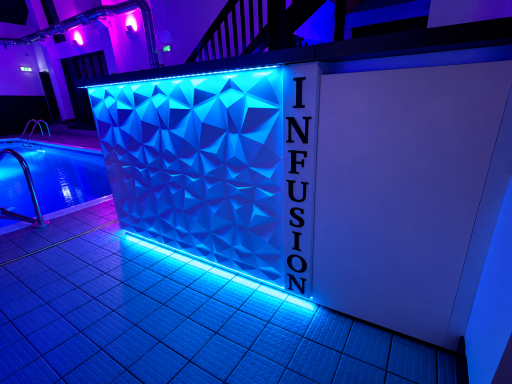 Geometric wall with blue lighting and the word "INFUSION" in a stylish font.