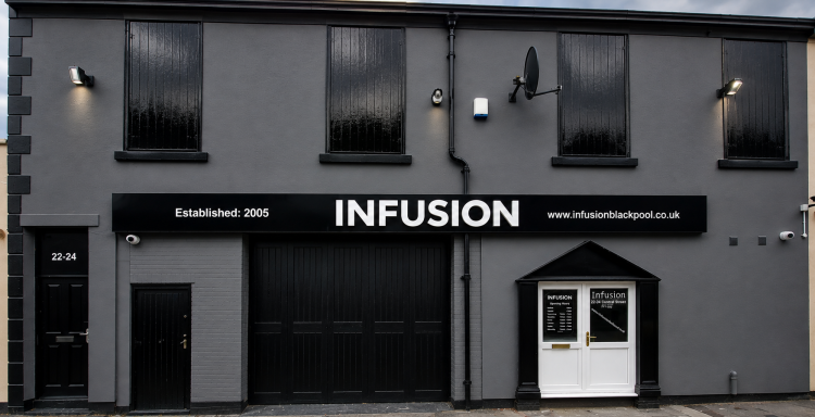 Exterior of a modern building featuring a large sign that reads "INFUSION."