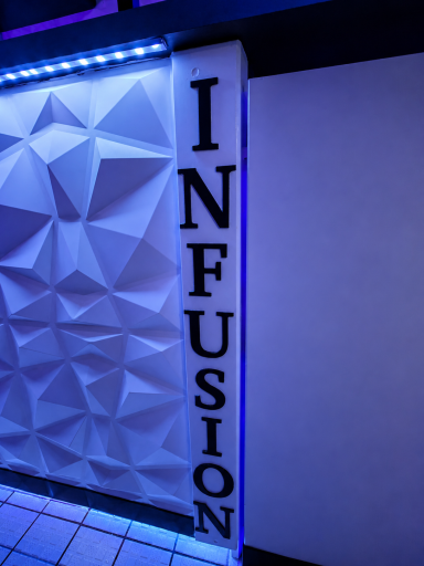 Stylish wall display with the word "INFUSION" in bold letters, illuminated by blue light.